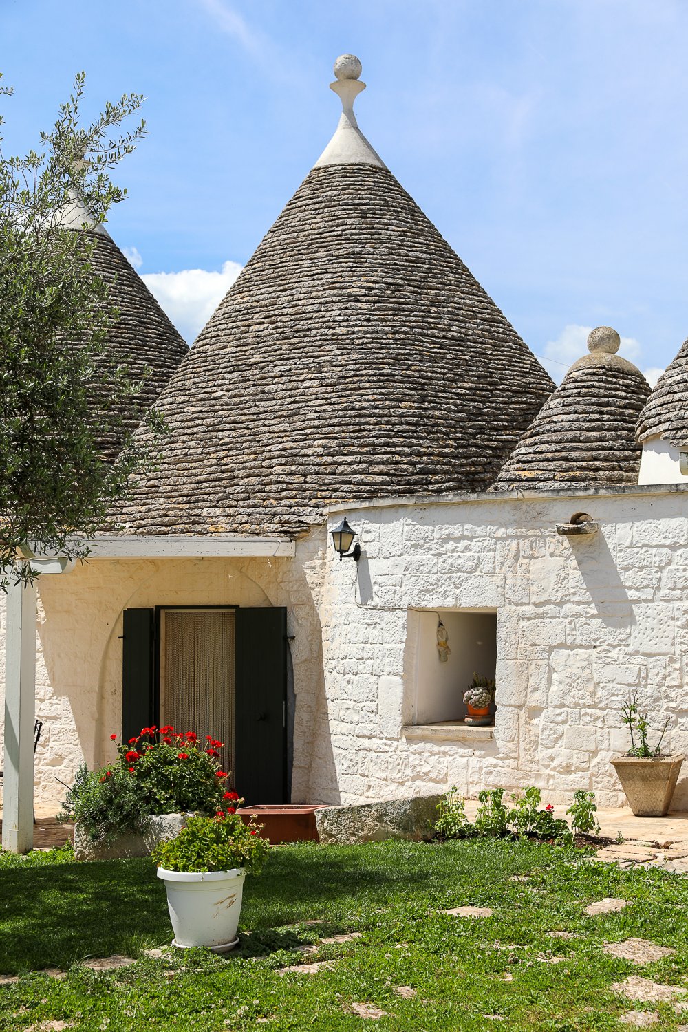 Little garden outside a trullo on a sunny day
