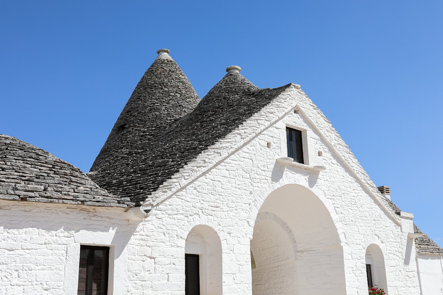 Trullo Sovrano under the clear, blue skies of Italy