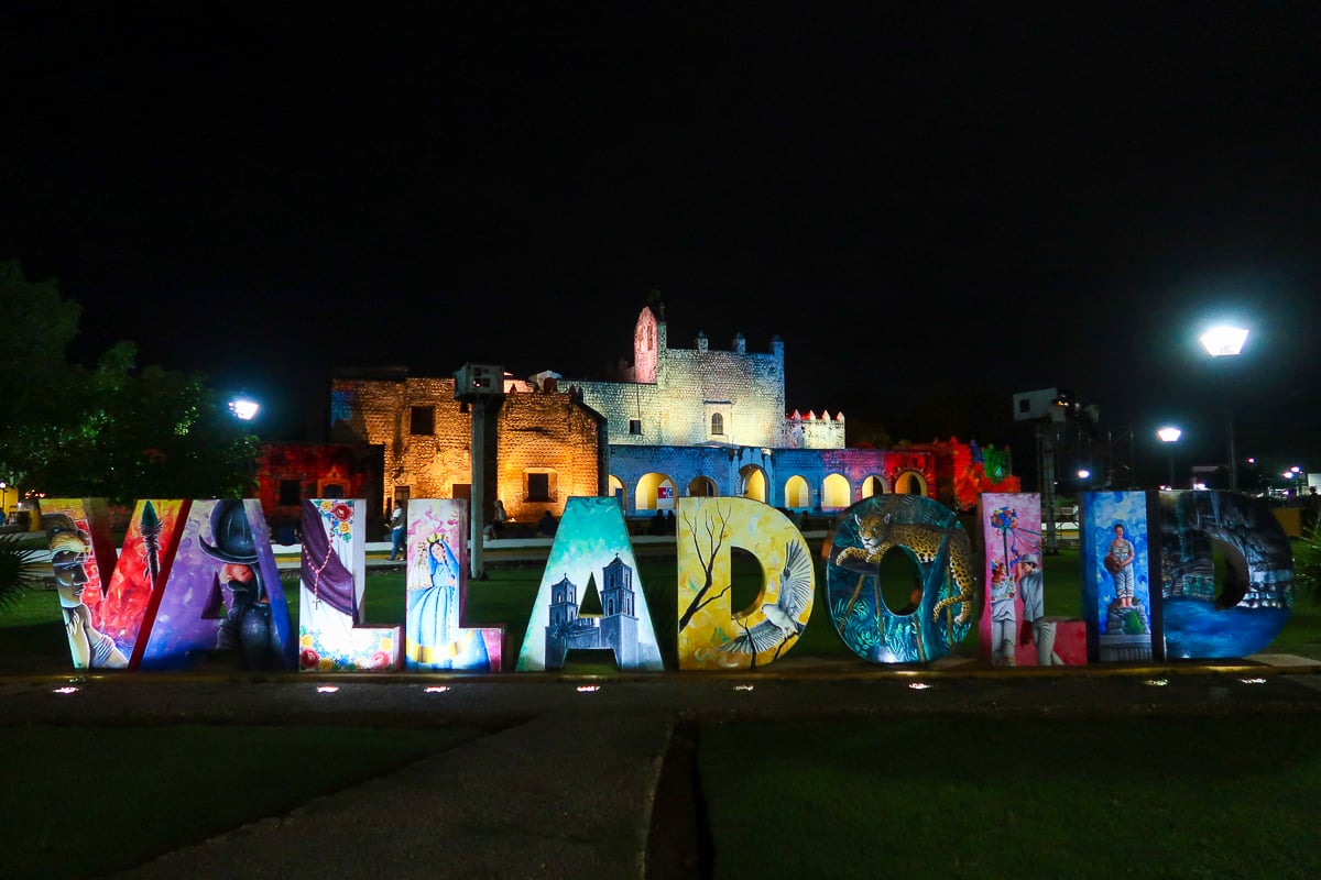 Colorful signage that reads "VALLADOLID" lit up at night. Watching the light show is one of the best things to do in Valladolid.