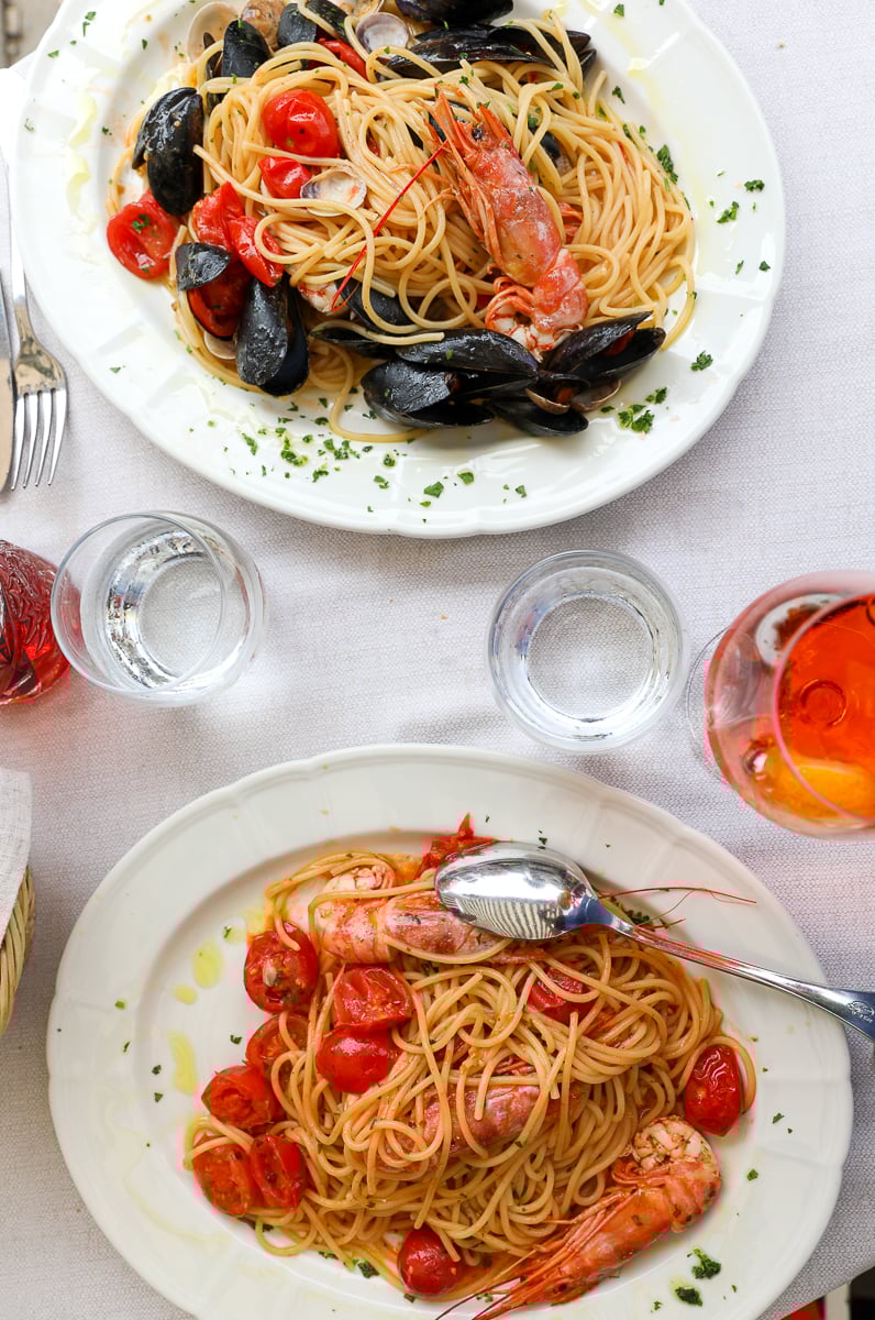two beautiful plates of traditional seafood pasta - this 2 days in Venice itinerary includes lots of recommendations for delicious places to eat in Venice!