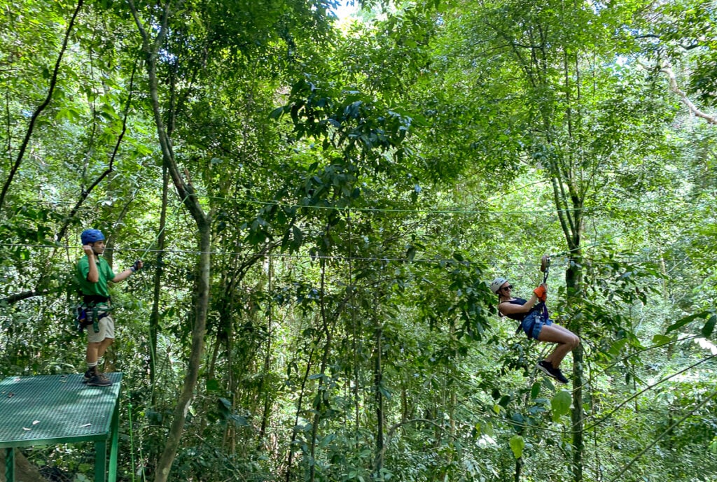 Maddy on a zipline. Ziplining through the lush jungles is one of the best things to do in Costa Rica.