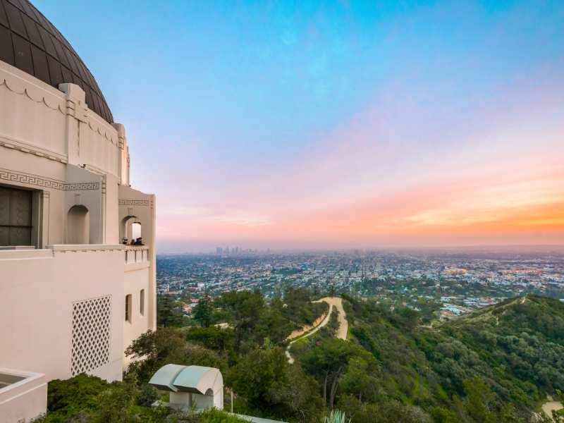 Griffith Observatory at sunset with the city skyline in the background