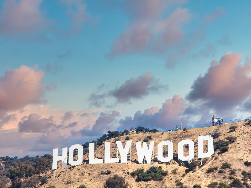 the Hollywood sign on brush-covered hills at sunset in LA