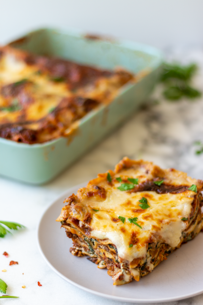The best vegetarian lasagna recipe, layered with vegan bolognese sauce (with mushrooms, lentils & walnuts), spinach-ricotta, mozzarella, and béchamel sauce!