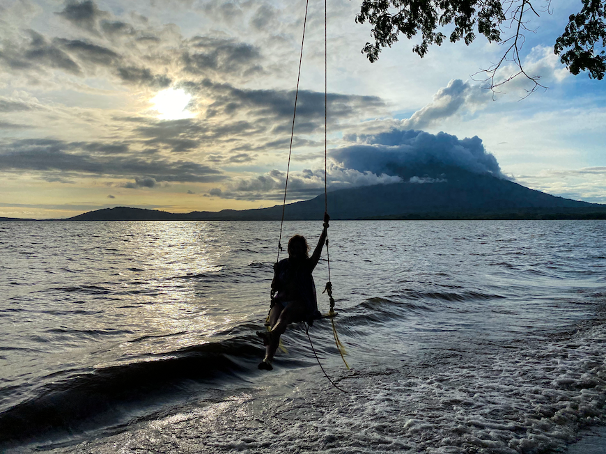 Melanie sitting on a rope swing in Ometepe, Nicaragua - she is a solo female traveler in Nicaragua with lots of experience to answer the question: "is traveling to Nicaragua safe?"