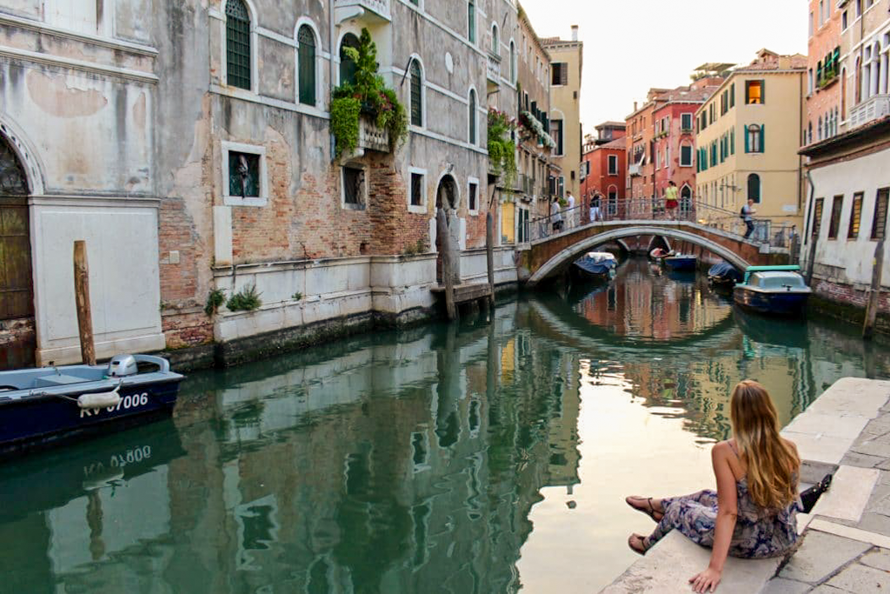 Maddy sitting on the canals in Venice