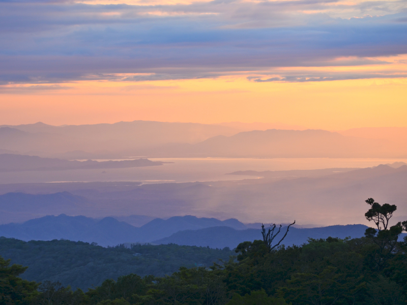 Beautiful sunset at Monteverde with blue-pink-yellow hues. Watching the sunset from a viewpoint is one of the things to do in Monteverde, Costa Rica.