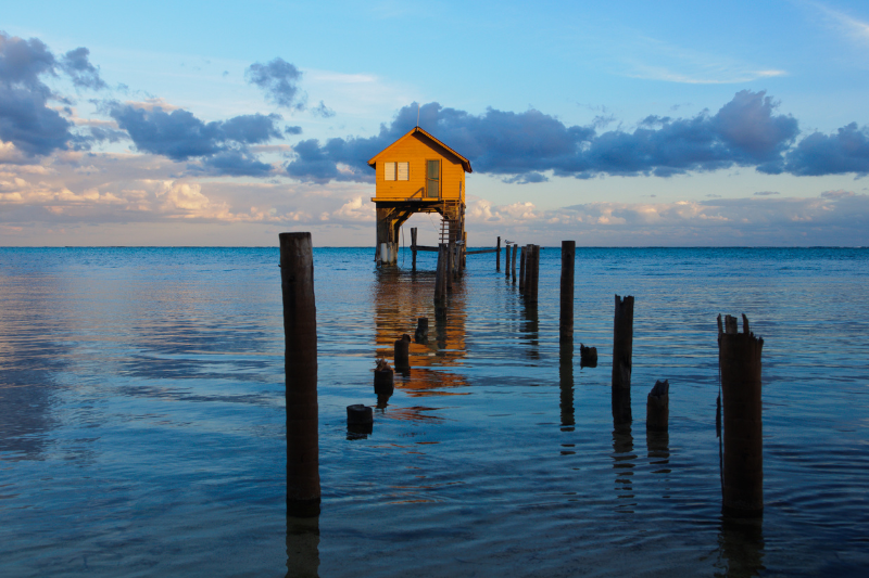 Ambergris Caye old wooden house over the ocean water