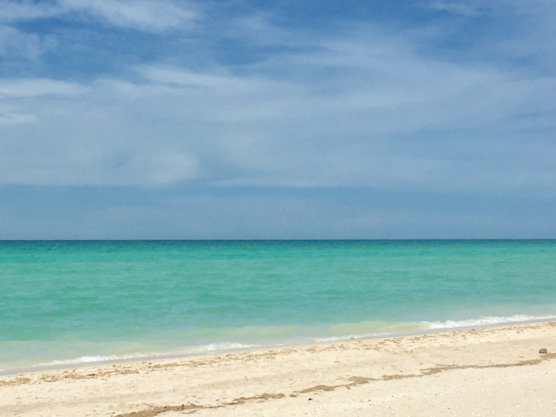 Turquoise waters by a white sand beach in Sisal, one of the best places to visit in Yucatan, Mexico