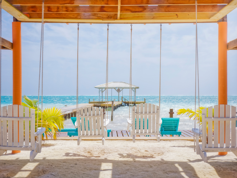 White swing chairs by the beach in Caye Caulker