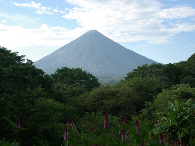 Green jungle and volcano in Nicaragua. Rainy season in Nicaragua is the best time to visit since it's cheaper, everything is green and lush, there are less crowds, and travel is cheaper.